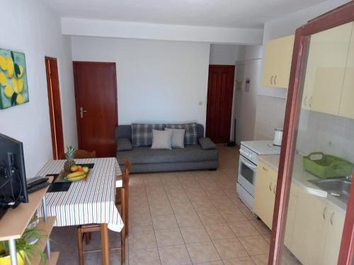 a kitchen and living room with a couch and a table at Apartments by the sea Ivan Dolac, Hvar - 21269 in Jelsa