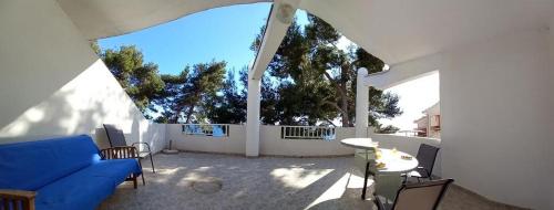 a living room with a blue couch and a large window at Apartments by the sea Ivan Dolac, Hvar - 21269 in Jelsa