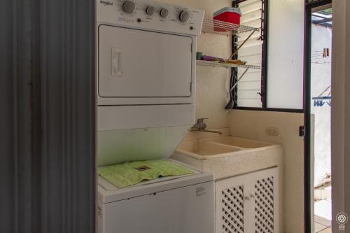 a small kitchen with a sink and an oven at Punta Leona, Al Pairo 52 in Punta Leona