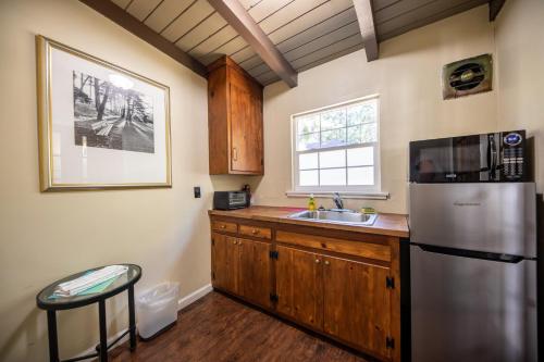 a kitchen with a stainless steel refrigerator and a sink at Emerald Bay Lodge in South Lake Tahoe