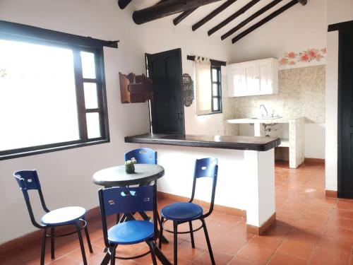 a kitchen with a table and chairs in a room at Casa Villa Ramos in Villa de Leyva