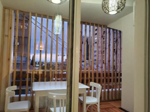 a dining room with a table and chairs and a window at PEATONAL Y SAN MARTIN MONOAMBIENTE in Mendoza