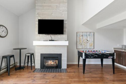 a living room with a fireplace and a table and a tv at Mountain View Wintergreen Home 84140 in Blue Mountains