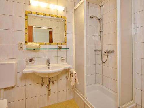 a bathroom with a sink and a shower at Haus Anton Sölden - Apartments & Zimmer in Sölden