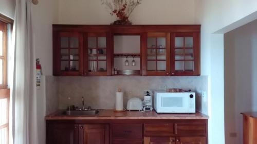 a kitchen with a sink and a microwave at Catcha Falling Star in Negril