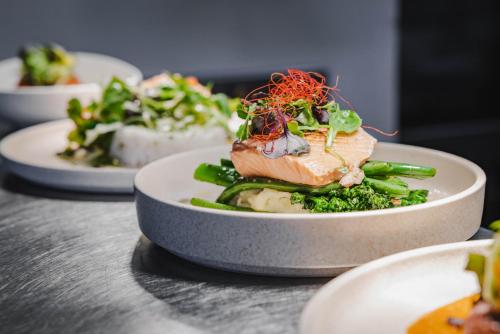 a plate of food with vegetables on a table at Hotel Verge Launceston in Launceston