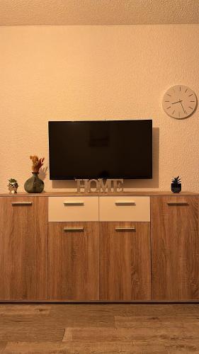 a flat screen tv sitting on top of a entertainment center at Studio COSY à deux pas de la PLAGE ! in Gruissan