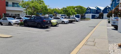 a row of cars parked in a parking lot at Ocean View Villa, 2 bedroom in Mandurah