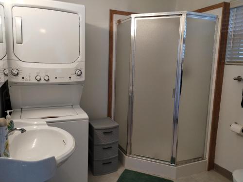 a bathroom with a shower and a toilet and a sink at Waterfront Cabin - Homer Seaplane Base in Homer