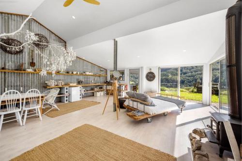 a living room with a table and a couch and a dining room at Molla Eco Lodge in Wattamolla