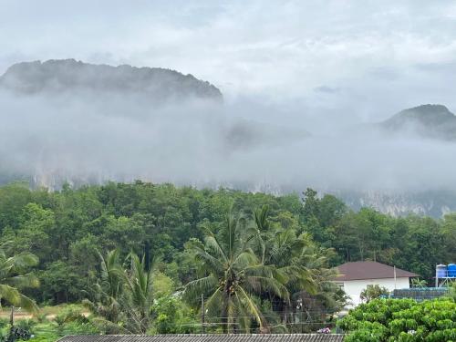 a view of a forest with clouds in the sky at Infinity Aonang Krabi in Ao Nang Beach