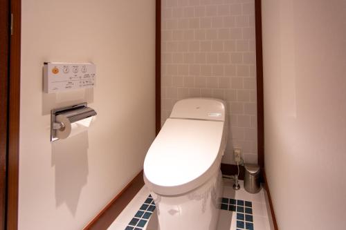 a bathroom with a white toilet in a stall at Premier Hotel Mojiko in Kitakyushu