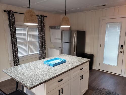 a kitchen with a counter with a blue box on it at Kure Beach Cottage-Fully Updated--1 block- welcome dogs for modest fee in Kure Beach