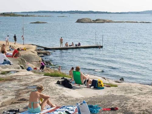 a group of people on a beach near the water at 5 person holiday home in VÄSTRA FRÖLUNDA in Gothenburg