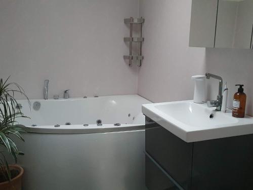 a bathroom with a bath tub and a sink at 5 person holiday home in VÄSTRA FRÖLUNDA in Gothenburg
