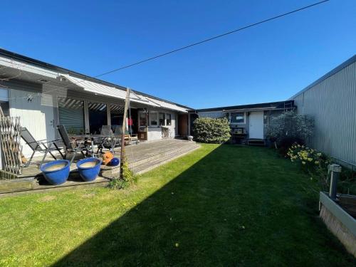 a backyard of a house with a wooden deck at 5 person holiday home in VÄSTRA FRÖLUNDA in Gothenburg