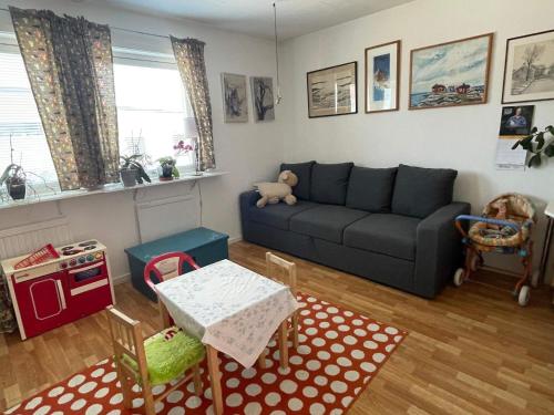 a living room with a couch and a table at 5 person holiday home in VÄSTRA FRÖLUNDA in Gothenburg