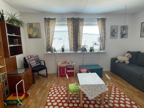 a living room with a couch and a table at 5 person holiday home in VÄSTRA FRÖLUNDA in Gothenburg