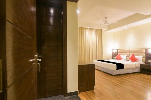 a hotel room with a bed and a door at Super Collection O Starlight in Kānpur