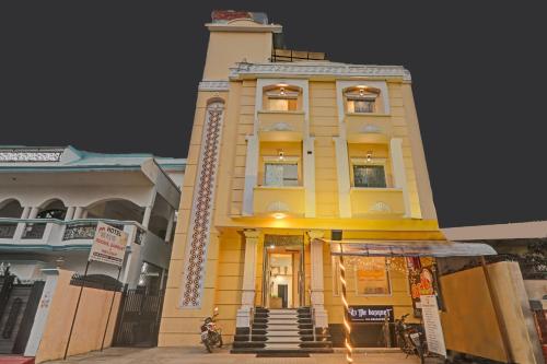 a yellow building with a clock tower on top at Townhouse Hotel Hridaya Inn in Lucknow