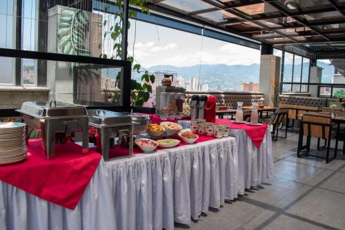a table with food on it with red and white table cloth at Edificio Helena in Medellín