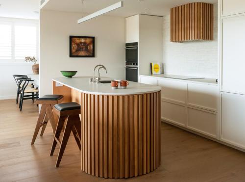a kitchen with a wooden island in the middle at Porters Boutique Hotel in Havelock North