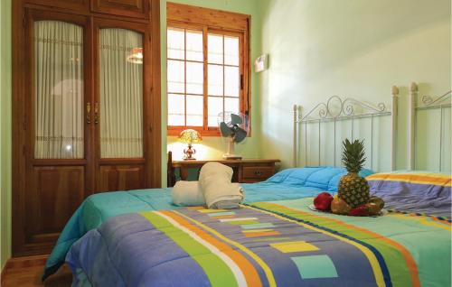 a bedroom with two beds with a pineapple on it at Amazing Home In Olvera With 4 Bedrooms, Wifi And Outdoor Swimming Pool in Olvera