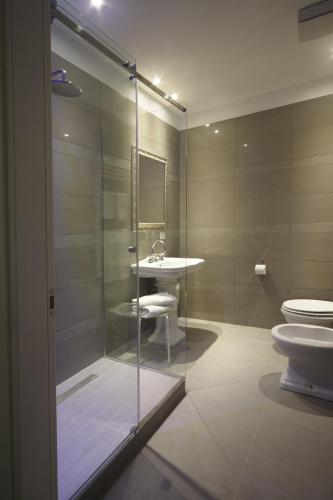 a bathroom with a shower and a toilet and a sink at Navigliotel 19 - Rooms & Suites in Milan