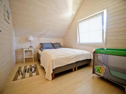 a bedroom with a bed in a small room at Comfortable, two-story holiday houses for 5 people, Pobierowo in Pobierowo