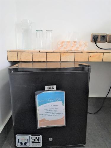 a table with glasses and bottles on top of a machine at Katara Gili, Boutique Rooms and Bungalows in Gili Trawangan