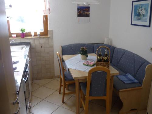 a small kitchen with a table and a blue couch at Ferienhaus Günter in Baiersbronn