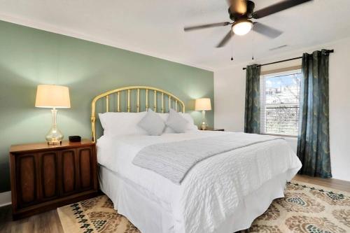 a bedroom with a white bed and a ceiling fan at Hawksbill Home~Hot Tub~Dog Friendly~Modern~Water Front Porch in Luray