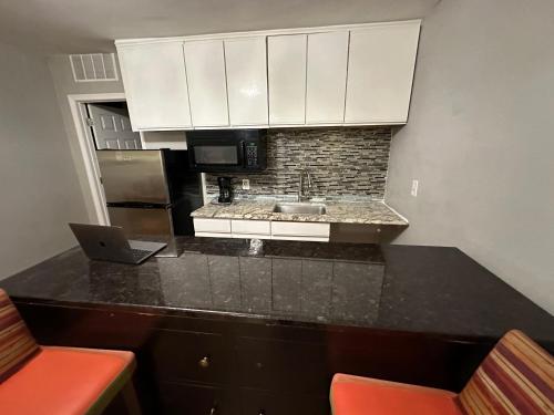 a kitchen with a counter top with a laptop on it at Almi in Washington