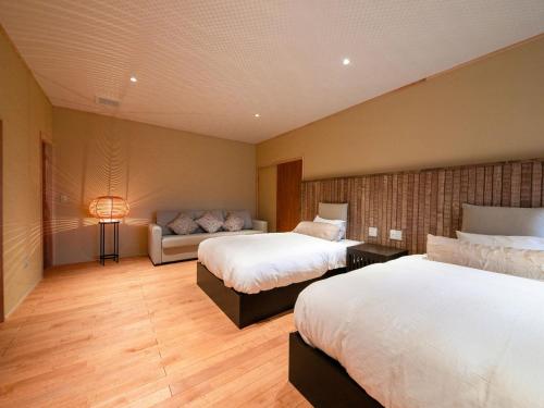 a hotel room with two beds and a couch at Tsuruya / Vacation STAY 59066 in Miyaji