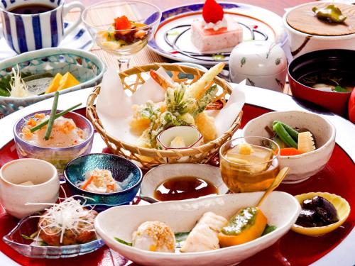 a table with many dishes of food on it at Tsuruya / Vacation STAY 59066 in Miyaji