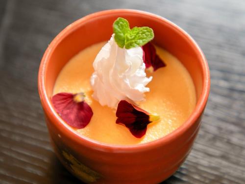 a cup of pumpkin pudding with whipped cream and a mint leaf at Tsuruya / Vacation STAY 59061 in Miyaji