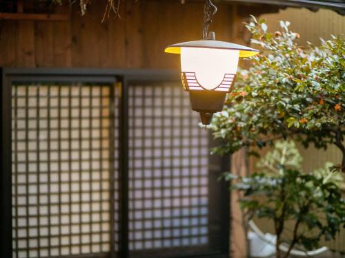 a light hanging in front of a door at Tsuruya / Vacation STAY 59061 in Miyaji