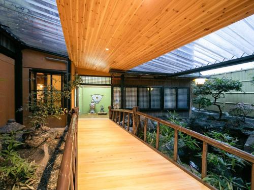 a wooden walkway in a house with an aquarium at Tsuruya / Vacation STAY 59065 in Miyaji