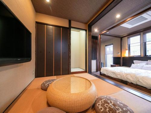 a room with a bed and a table with a hat on it at Tsuruya / Vacation STAY 59052 in Miyaji
