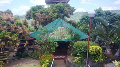 a tree house with a sign in front of it at La Virginia Leisure Park and Amusement in Mataasnakahoy
