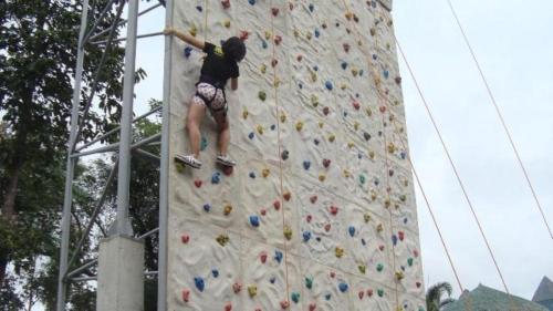 a man climbing a rock wall on a climbing wall at La Virginia Leisure Park and Amusement in Mataasnakahoy