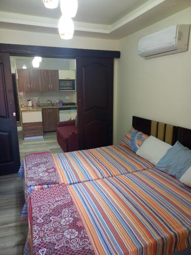 a bedroom with a bed and a living room at شاليهات للمصايف بقرية جولف بورتو مارينا الساحل الشمالي in El Alamein