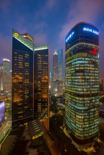 a group of tall buildings in a city at night at Pudong Shangri-La Shanghai - With a sweeping view of the Pearl Tower and the historic Bund skyline in Shanghai