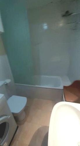 a bathroom with a white toilet and a sink at Mini-apartament cèntric a Platja d'Aro in Platja d'Aro