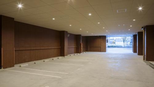 an empty room with a large room with tables and chairs at Toyoko Inn Kyoto Nijojo Minami in Kyoto