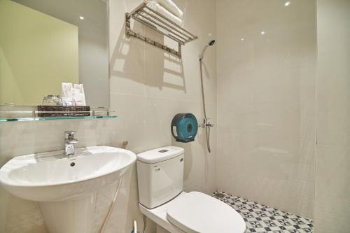 a bathroom with a white toilet and a sink at Bin Bin Hotel 2 - Near Him Lam D7 in Ho Chi Minh City