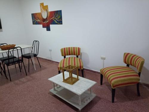 a room with two chairs and a table and a table and a table at Sarratea 1427 in Santiago del Estero