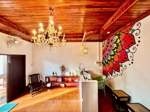 a living room with a chandelier on the ceiling at La Casa Hostel in Luang Prabang