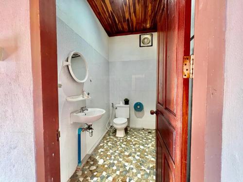 a bathroom with a toilet and a sink at La Casa Hostel in Luang Prabang