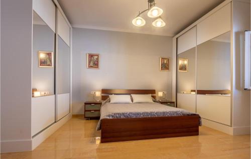 a bedroom with a bed and a large mirror at Nice Home In Baena With Outdoor Swimming Pool in Baena